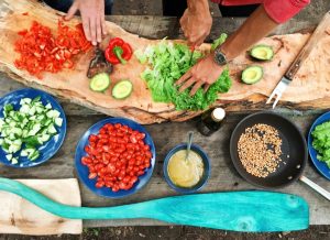 person slicing green vegetable